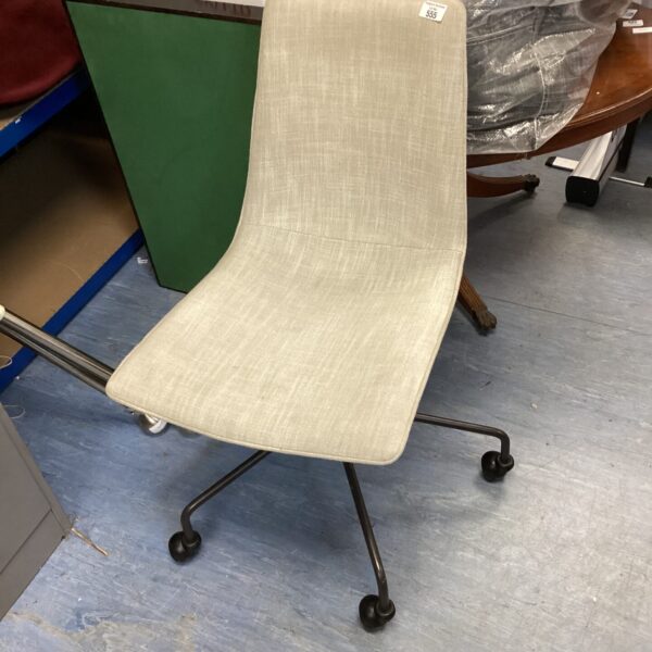 Vintage office chair with chrome base and neutral fabric seat.