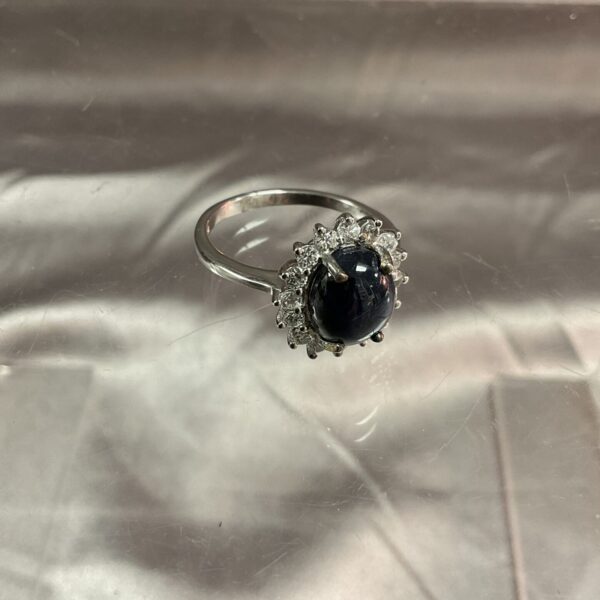 Close-up of a silver ring with a deep blue lapis lazuli cabochon.