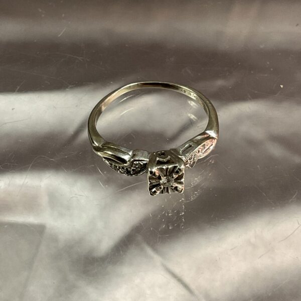 Sparkling diamond set in a 14K white gold ring, size P.