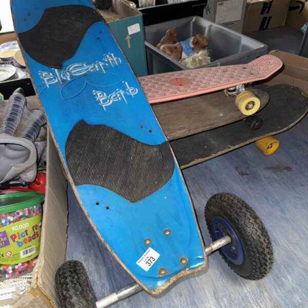 Blue off road skateboard with large pneumatic tires.