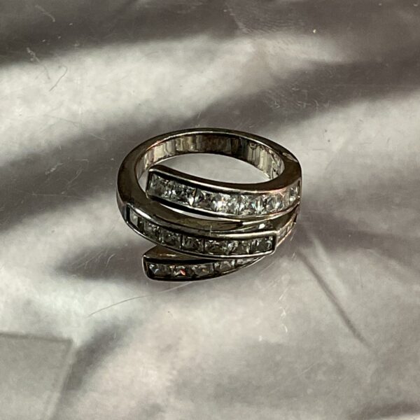 Close-up of a white stone ring, size N.