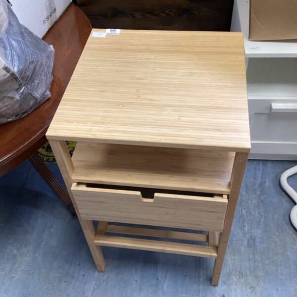 Wooden bedside cabinet with a single drawer, ideal for bedroom storage.