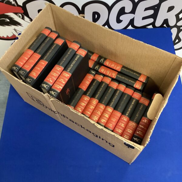 Stack of vintage Agatha Christie crime novels in a cardboard box.