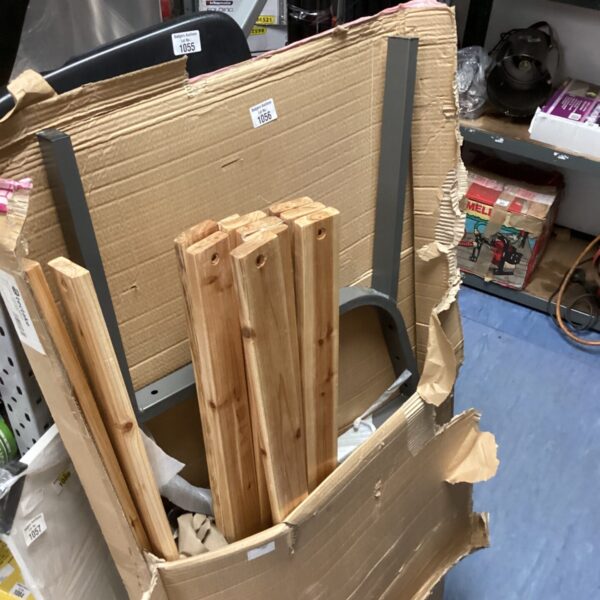 Components of a teak garden bench kit in original packaging.