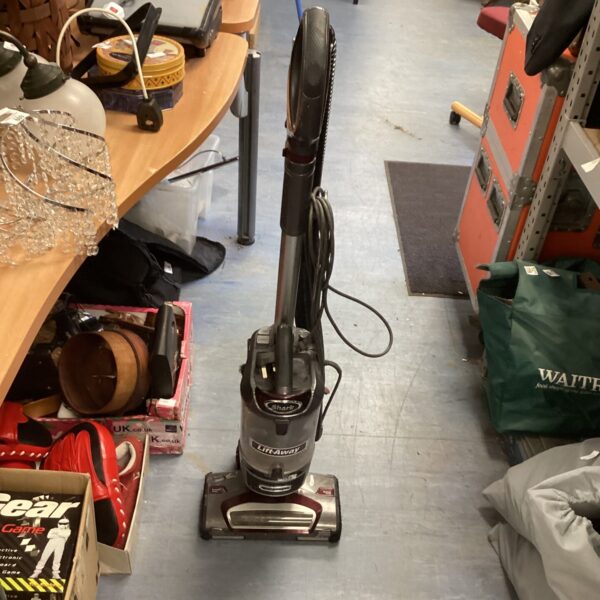 Used Shark Liftaway vacuum cleaner in a home setting.