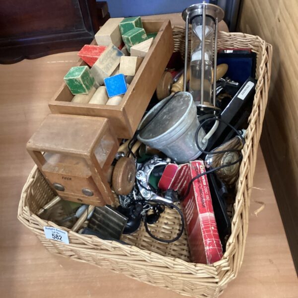 Wicker basket filled with vintage collectibles and a wooden truck.