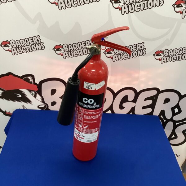 Vintage red Priority Co2 fire extinguisher, collectible fire safety equipment.
