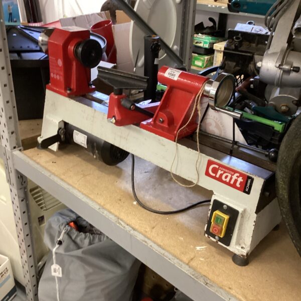 Front view of an Axminster lathe in a workshop setting.