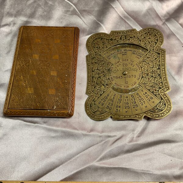 Vintage brass calendar spanning 1943 to 1970, collectible desk accessory.