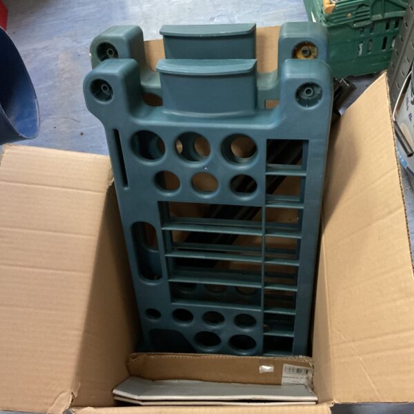 Plastic garden shelf unit with metal uprights for outdoor storage.