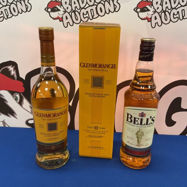 Whiskey bottles and box, including Bells and Glenmorangie brands.