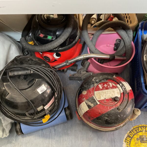 Red Numatic Henry hoover and cleaning accessories in a collection.