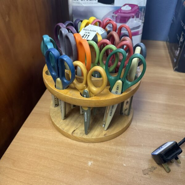 Assorted vintage fabric cutting scissors for sewing and crafting.