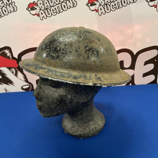 Vintage WWII Air Raid Warden helmet, showing signs of wear.