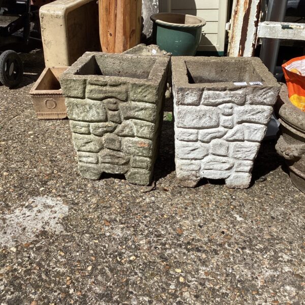 Pair of stone effect garden planters for outdoor use.