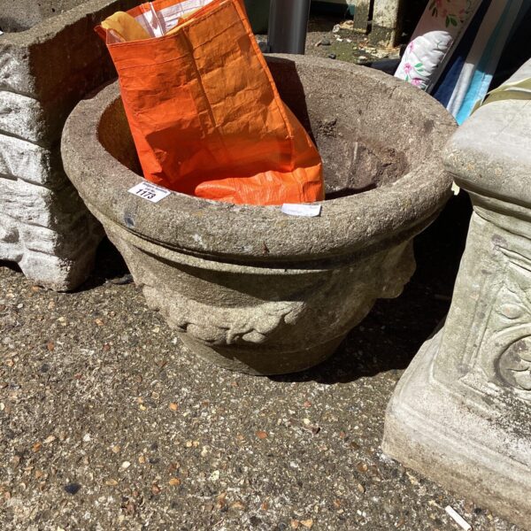 Classic stone garden planter for outdoor plants and decor.