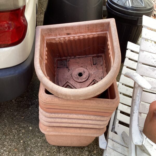 Terracotta garden tub displayed outdoors, showing signs of weathering.