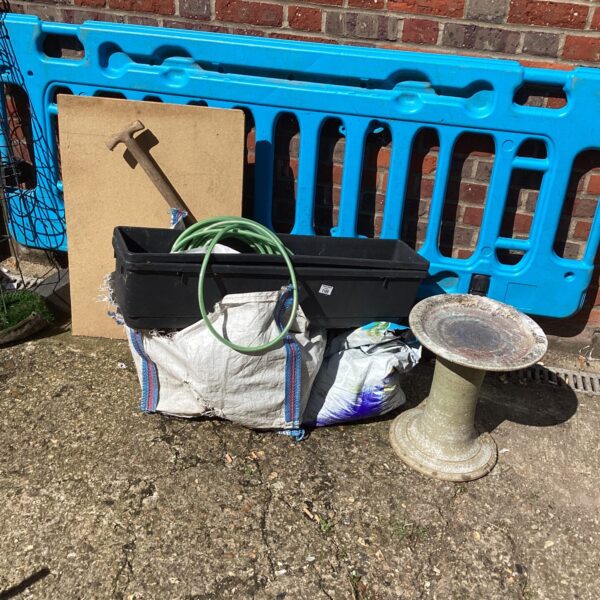 Mixed lot of garden planters and troughs for outdoor use.
