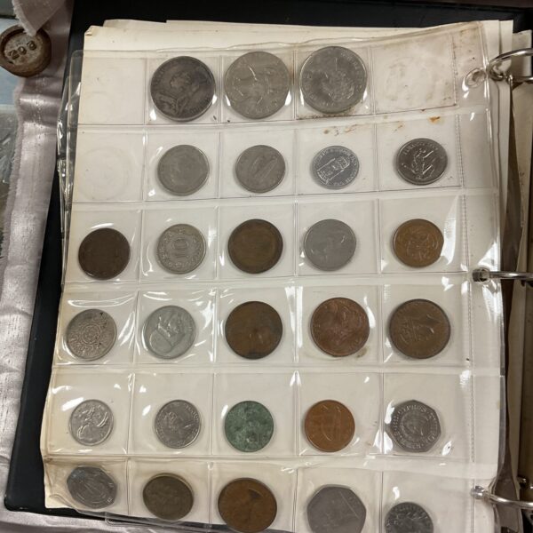Close-up of a coin album filled with assorted vintage coins.