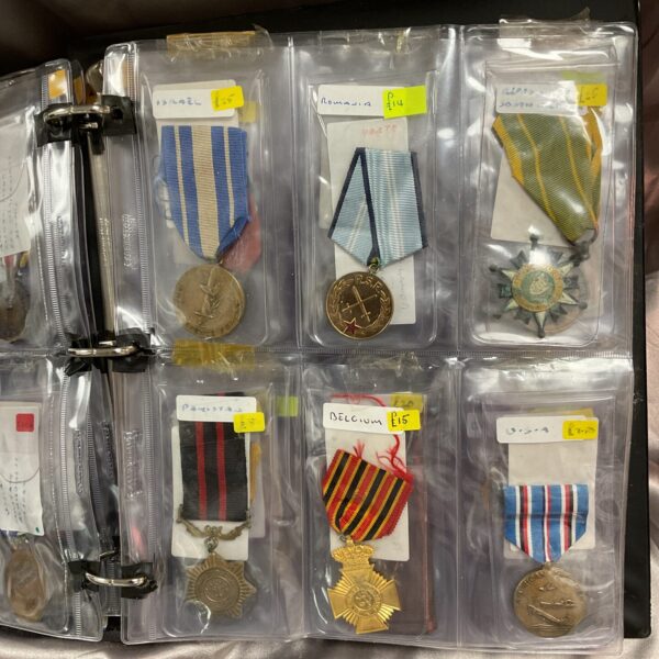 Front view of an overseas medal album with various medals displayed.