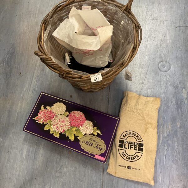 Vintage wicker basket filled with antique haberdashery crafting supplies.