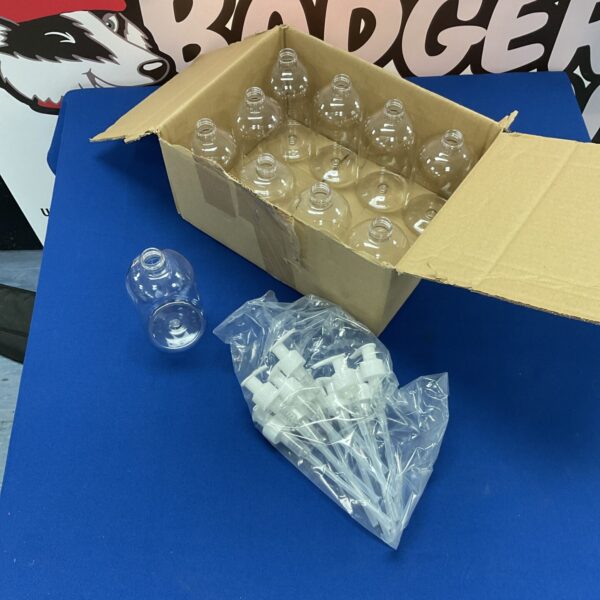 Clear plastic liquid soap dispensers in a cardboard box.