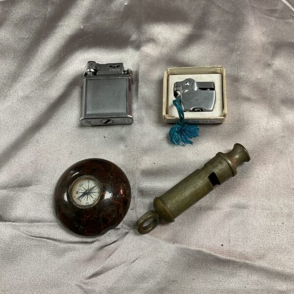 Vintage lighters, compass, and whistle set for collectors.