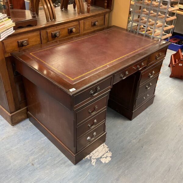 Rich mahogany vintage leather top desk with drawers.