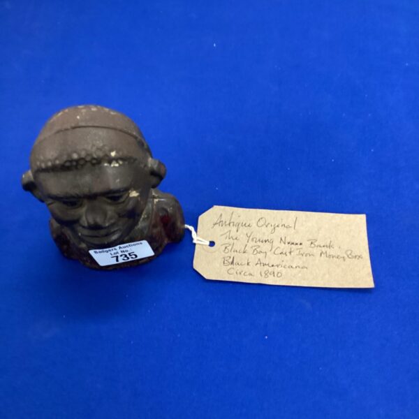 Antique Black Americana cast iron money box from circa 1890.