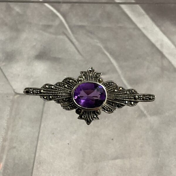 Vintage silver brooch with amethyst and marcasite stones.