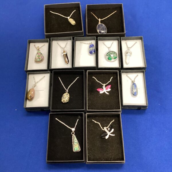 Silver pendants featuring abalone shell and lapis lazuli stones.