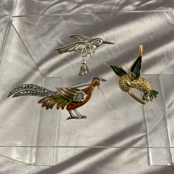 Vintage bird brooch collection featuring kingfisher and hummingbird.