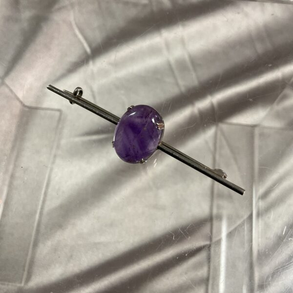 Vintage silver brooch with a purple amethyst cabochon.