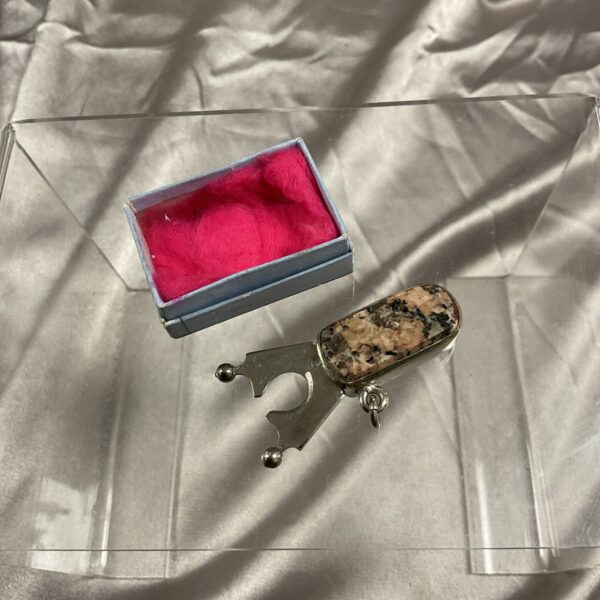 Vintage cheroot cutter fob with stone inlay and retractable blade.