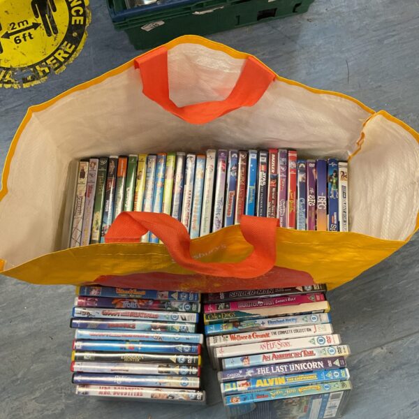 A colourful bag of children's DVDs including Disney movies.