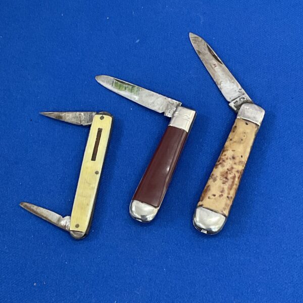 Lot of three vintage pocket knives with bone and celluloid handles.