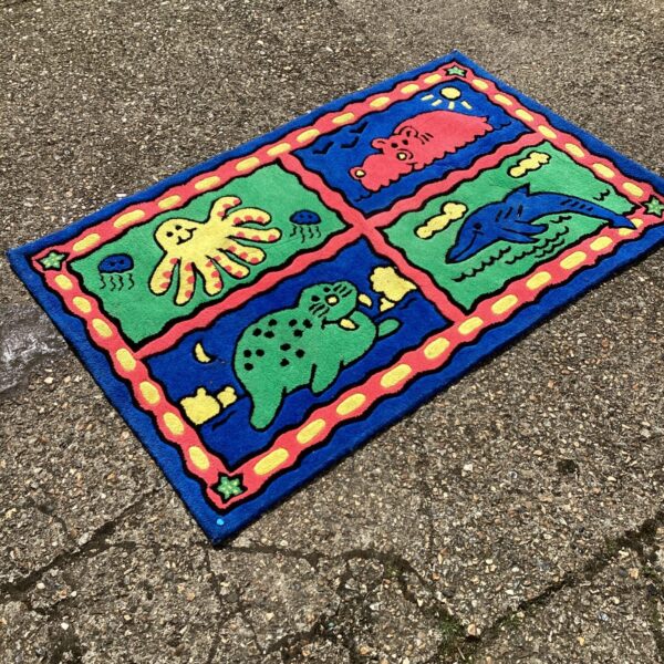 Brightly coloured water world rug with cartoon sea creatures.