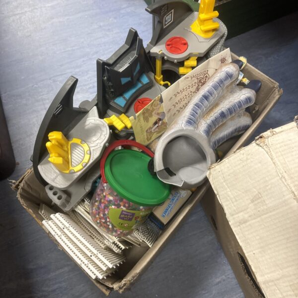 Colourful children’s toy lot presented in a cardboard tray.