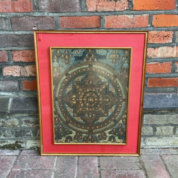 Framed Asian devotional mural with intricate religious artwork.
