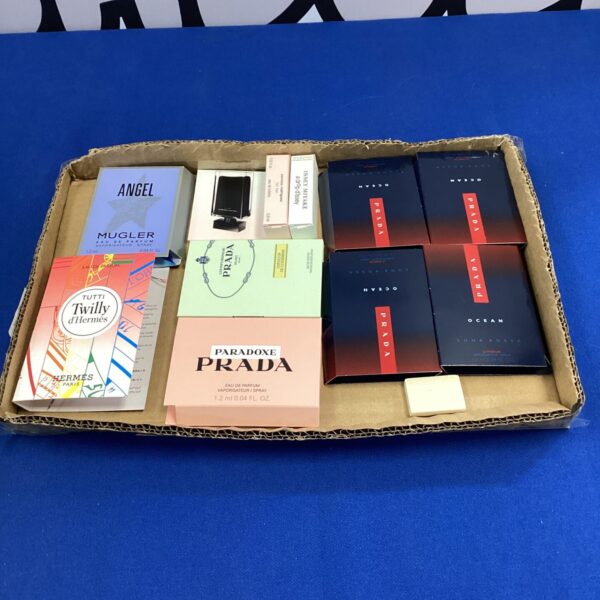 Perfume sample tray featuring Prada and Hermes fragrances.
