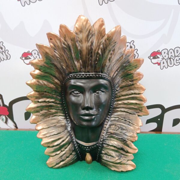 Detailed ceramic bust of a Native American chief with feathered headdress.