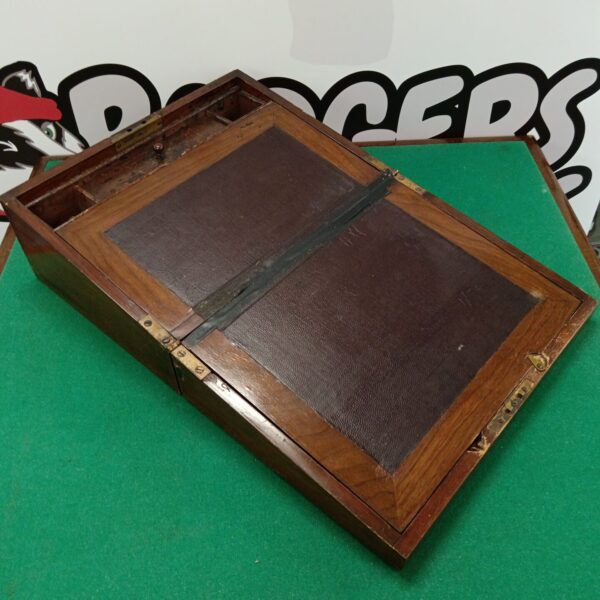 Open vintage mahogany writing slope showing interior compartments.