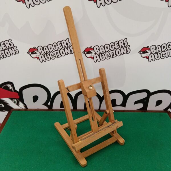 Small wooden tabletop artists easel for art display.