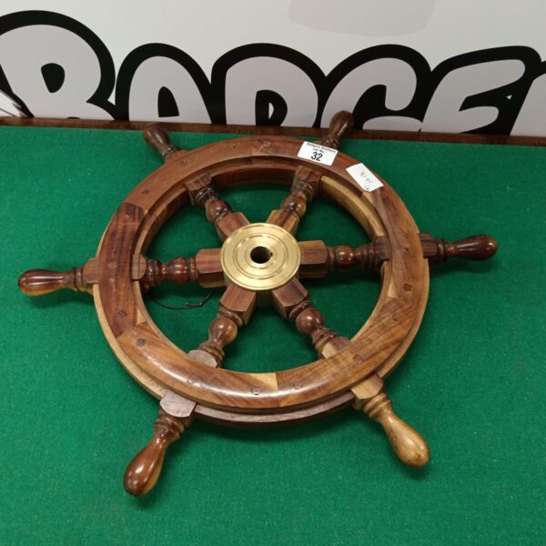 Vintage wooden boat wheel for nautical decor and collecting.