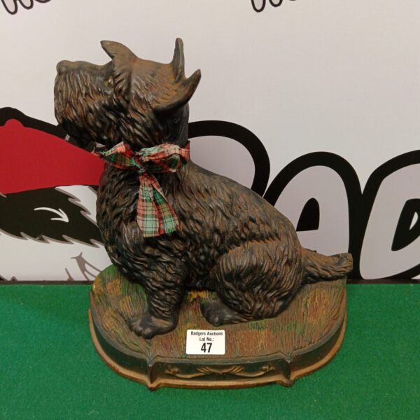 Vintage cast iron Scottie dog doorstop with detailed fur texture.
