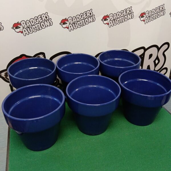 Lot of six blue plastic plant pots for garden or home use.