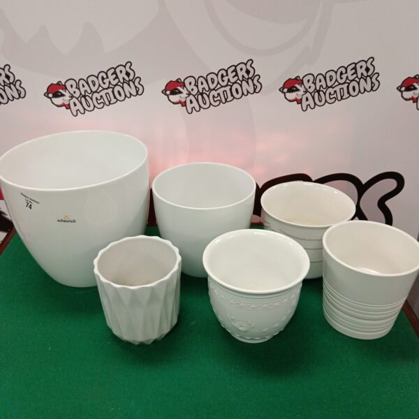 White ceramic plant pots including Scheurich planters for garden decor.