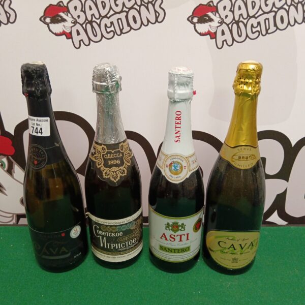 Collection of four sparkling wine bottles, including Asti and Cava.