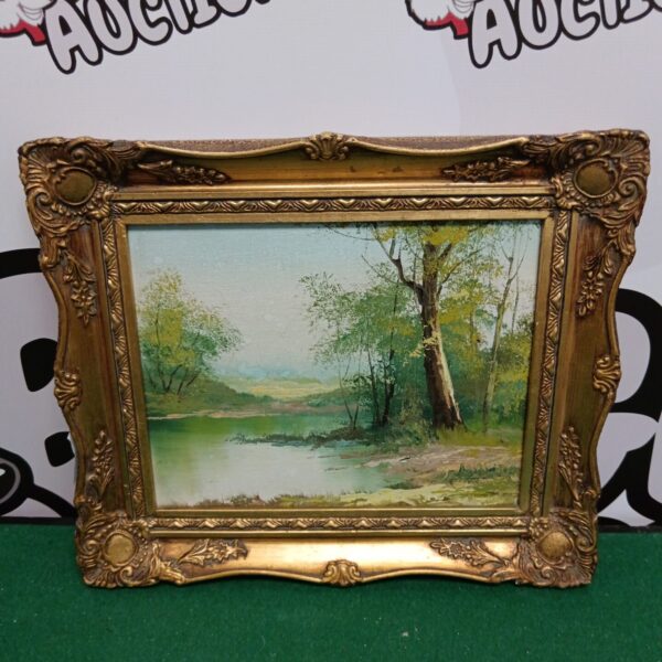 Small gilt framed oil painting of a river woodland scene.