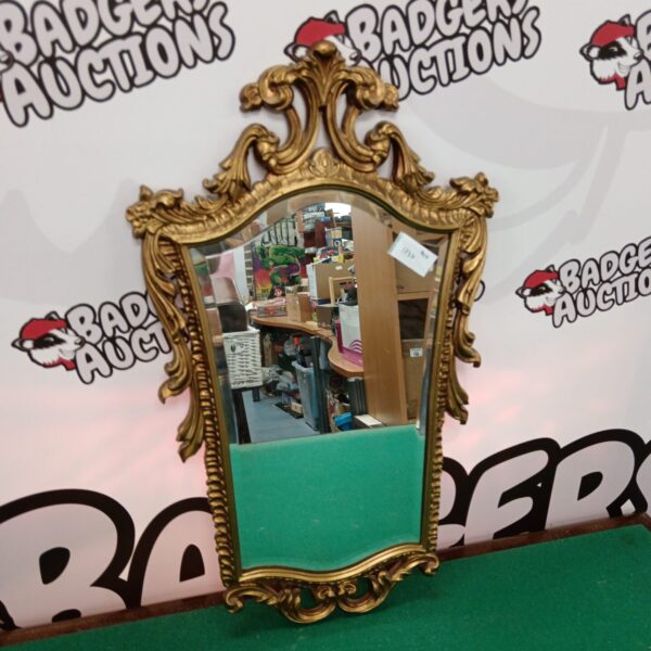 Ornate gilt framed French style boudoir mirror for home decor.